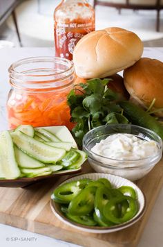 pickles, cucumbers, and mayonnaise on a cutting board