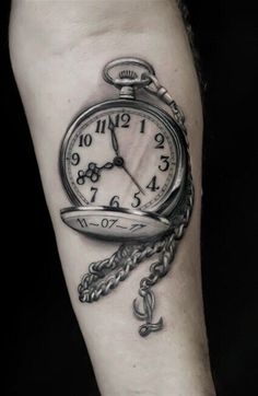 a man with a tattoo on his arm that has a clock and chain attached to it