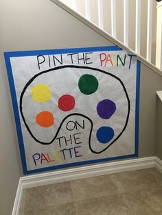 a sign that says pin the paint on the palette next to a stair case in a house