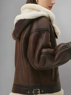 Elevate your winter wardrobe with our exquisite Women’s Chocolate Brown Leather Shearling Removable Hood Coat. This luxurious coat combines style and functionality, offering the perfect blend of sophistication and warmth for the colder months. Crafted from rich chocolate brown leather, this coat exudes elegance and timeless charm. The buttery soft leather adds a touch of luxury to your ensemble, while the rich brown hue complements a variety of outfits, from casual to formal. The removable shearling hood adds versatility to the coat, allowing you to customize your look based on the weather and occasion. Designed with comfort in mind, this coat features plush shearling lining throughout the interior, providing insulation against the cold while keeping you cozy and snug. The shearling collar Luxury Brown Outerwear For Cold Weather, Luxury Hooded Outerwear With Faux Fur Lining, Hooded Sheepskin Outerwear With Fleece Lining, Hooded Shearling Outerwear For Winter, Luxury Hooded Fur Coat For Cold Weather, Fall Sheepskin Outerwear With Detachable Hood, Luxury Winter Sheepskin Coat, Hooded Outerwear With Faux Fur Trim And Sheepskin, Hooded Outerwear With Faux Fur Trim In Sheepskin