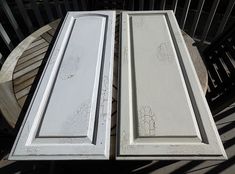 two white doors sitting on top of a wooden table