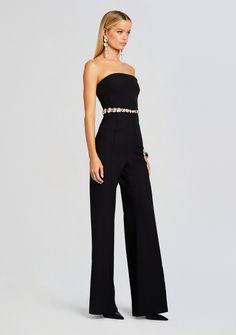 Stand out in style with our Glenda Jumpsuit. This chic and elegant black strapless jumpsuit adorned with an embellished waist is your ticket to commanding the spotlight. Perfect for upscale events, this jumpsuit ensures you exude confidence and grace. Shown here in Black/Silver. 100% Polyester Made in India Model is 5' Chic Embellished Jumpsuit For Gala, Elegant Strapless Jumpsuits And Rompers For Gala, Elegant Strapless Jumpsuits And Rompers For Night Out, Elegant Embellished Pantsuit For Party, Elegant Strapless Jumpsuit For Gala, Elegant Strapless Jumpsuits And Rompers, Strapless Pantsuit For Night Out, Elegant Strapless Jumpsuits And Rompers For Party, Elegant Embellished Formal Pantsuit