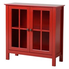 a red cabinet with glass doors on the front and bottom shelf, against a white background