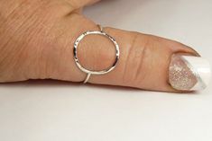 A hammered circle ring made with 18 gauge wire. Modern and simple minimal jewelry. Made with sterling silver Handmade and polished to a high shine in my shop. The circle symbol meaning is universal, sacred and divine. It represents the infinite nature of energy, and the inclusivity of the universe. Purity ring, karma ring, midi ring modern and simple Moisture in the air or on the skin can react with the %7 copper present in all Sterling Silver jewelry, causing a green discoloration. size 4-13 1/ Minimalist Hammered Sterling Silver Midi Rings, Hammered Sterling Silver Midi Rings, Silver Hammered Minimalist Midi Rings, Simple Hammered Rings, Simple Silver Round Midi Rings, Hand Forged Sterling Silver Stackable Rings, Hammered Sterling Silver Round Ring, Silver Hammered Midi Rings, Karma Ring