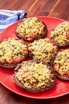 baked stuffed mushrooms on a red plate with parmesan cheese