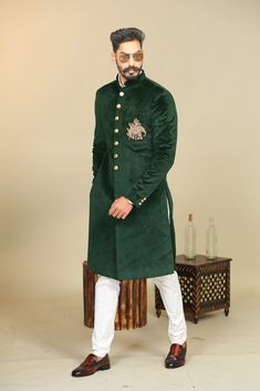 "Important Instrucitons : We request you to kindly calculate the processing time of your order after the mutual confirmation on Bespoke measurements between us has taken place (either via message , e mail or form) \"Crafted with Passion in India; loved by men across the USA, Canada, Europe\" Material: Velvet Color: Dark Green with Golden Elephant Embroidery Collar type: Mandarin , Sherwani with 7 Buttons Package contents: 1 Achkan + 1 Churidar Pajama Wash Care Instruction : Dry-clean only Achkan Long Sleeve Kurta With Dori Work For Reception, Embroidered Long Sleeve Kurta For Reception, Traditional Green Nehru Jacket For Reception, Green Nehru Jacket With Zari Work For Reception, Anarkali Style Embroidered Nehru Jacket For Reception, Embroidered Green Churidar For Reception, Embroidered Long Sleeve Churidar For Reception, Green Bandhgala With Zari Work For Reception, Green Bandhgala For Reception On Eid