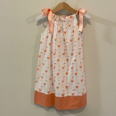 Nwot 3t Handmade Flamingo Dress! Original Owners. Never Worn Or Tried On. I Purchased This Little Dress At The Farmers Market Here In Pensacola, Fl But My Daughter Never Got Around To Wearing It. It’s Adorable And Handmade. Peach Ribbon That Ties At The Top. White Sleeveless Cotton Twirl Dress, White Summer Twirl Dress For Playtime, White Twirl Dress For Summer Playtime, White Playful Twirl Dress For Summer, White Summer Twirl Dress For Dress-up, Playful White Twirl Dress For Summer, Playful Orange Cotton Dress, Cute Orange Cotton Sundress, Playful White Sundress For Play