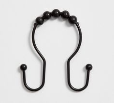 a pair of black beaded hooks on a white background