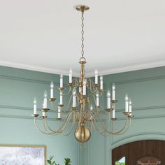 a chandelier hanging from the ceiling in a room with blue walls and wooden floors