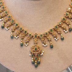 A lovely decorative piece featuring faceted and cabochon emerald drops, natural seed pearls and a plethora of diamonds! They are all set in 22k yellow gold giving the necklace a bright yellow color.    Length: 15.5 inches    Weight: 38.3 grams Elegant 22k Gold Emerald Necklace For Celebration, Festive Gold Necklace With Emerald, Festive 22k Gold Elegant Emerald Necklace, Gold Necklace With Stones, Traditional Gold Emerald Necklaces, Elegant 22k Gold Green Emerald Necklace, Elegant Green Emerald 22k Gold Necklace, Elegant Green Emerald Necklace In 22k Gold, Festive Green Pearl Drop Necklace