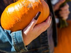 a person holding a pumpkin in their hands