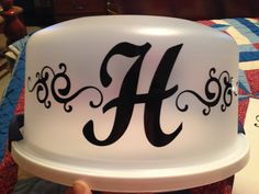 a hat with the letter h on it is being held by someone's hand