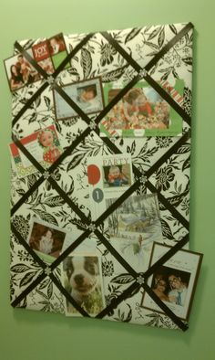 a bulletin board covered in pictures and magnets on a green wall with photos pinned to it