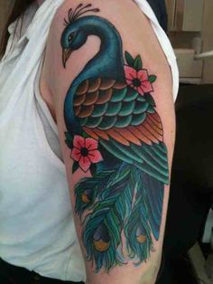 a woman with a peacock tattoo on her arm