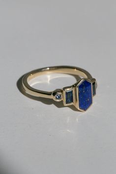 Art deco inspired ring with lapis lazuli and blue sapphires. Lapis Lazuli is inlaid into the elongated hexagon, measuring 9.5mm x 5mm. Accent blue sapphires are approximately .30 total carat worth. Millimeter measurement from end to end is 15mm. The setting is hand-carved and cast in your choice of gold color and karat. The band is 1.75mm thick. Please leave a note at checkout with your preferred size. All gems and rocks are nuanced and color, please know that your ring will be very similar to t Lapis Rings For Women, Lapis Lazuli Ring Gold, Carved Lapis Ring, Blue Octagon Art Deco Jewelry, Lapis Lazuli Mirror, Lapiz Lazuli Ring, Lapis Jewelry, Lapis Ring, Lapis Lazuli Ring