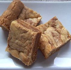 four pieces of brownie sitting on top of a white plate