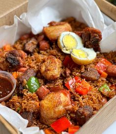 a box filled with rice, meat and veggies