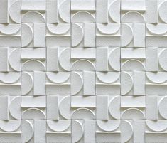 an abstract white tile pattern with rounded shapes and wavy lines on the side of it