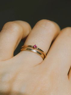 July’s birthstone - tiny ruby ring on our signature bark texture 14k yellow gold band. Dainty, delicate beauty. Perfect a lady who is not a fan of chunky gemstones, this ring won't get tangled in your clothes or hair. Match perfectly when you wear it with our dainty rings. Made of 14K yellow gold. Genuine ruby size 2 mm. Band width approximately 1.2 mm. Ruby Stackable Promise Ring, Fine Jewelry Stackable Ruby Promise Ring, Gold 14k Ruby Promise Ring, Gold 14k Promise Ruby Ring, Ruby Ring With Round Band For Promise, Gold Ruby Promise Ring In 14k Gold, Stackable Gold Ruby Rings, Promise Ruby Ring With Birthstone, Red 14k Gold Stackable Birthstone Rings