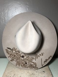 "We love our modern country brides! We design unique hats with our beautiful brides in mind, this is the perfect modern country accessory to wear on your big day and beyond! This hat is perfect for the bride who loves minimal custom design! The perfect hat for every season of weddings. These hats are felt/wool with a wide, flat brim.  Sizes vary for different colors. For Cream and Silverbelly sizes are small, medium, and large. Ivory hats are one size fits all. Hats come in four colors; Cream, S Bride Felt Hat, Burned Wedding Hat, Custom Wedding Hats, Bridal Cowgirl Hat, Western Style Wedding Hat With Flat Brim, Western Style Flat Brim Wedding Hat, Western Flat Brim Wedding Hat, Western Fedora Hat For Wedding, Adjustable Short Brim Hat For Weddings