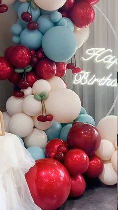 a bunch of balloons that are in the shape of a tower with cherries on it