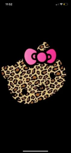 an animal print hello kitty with pink bow on it's head in the dark