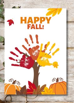 a happy fall card with handprints on it and leaves around the print area