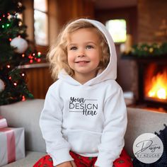 Introducing our baby toddler holiday sweatshirt mockup! A perfect mock for a diverse Christmas or New Years design, and more! Our mockup is ideal for Gildan 18500, Bella Canvas, Comfort colors 1567, or universal brands. Compliment your unique design this holiday season featuring this high quality digital mockup, showcasing an toddler / child modeling a white Hoodie Pullover Sweatshirt with Christmas backdrop. This mockup will help spread the holiday cheer in your Etsy shop while elevating your d Universal Sweatshirt, Toddler Modeling, Holidays With Toddlers, Christmas Backdrop, Digital Mockup, Hoodie Mockup, White Pullover, Sweatshirt Mockup, New Year Designs