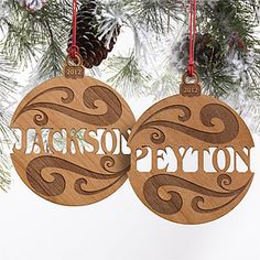 two wooden ornaments hanging from a christmas tree