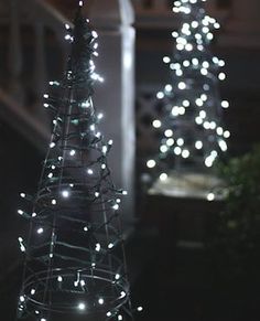 a lit up christmas tree in front of a building