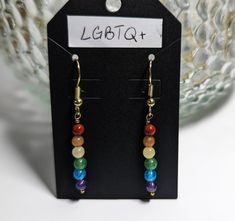 Earrings are designed in the colors of the classic rainbow LGBTQ+ flag.  Nickel and Plastic Free. The gemstones used are: 4mm red jasper, 4mm orange aventurine, 4mm pineapple aventurine, 4mm green aventurine, 4mm blue aventurine, and 4mm amethyst on gold-plated brass ear wire. Rainbow Round Bead Earrings For Gifts, Rainbow Round Beads Earrings For Gift, Rainbow Round Beaded Earrings As Gift, Lgbtq Flag, Orange Aventurine, Blue Aventurine, Lgbtq Flags, Rainbow Earrings, Red Jasper