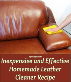 a person cleaning a brown leather chair with a yellow sponge