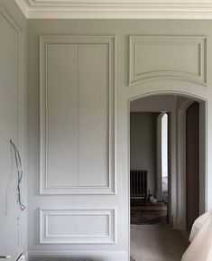 an empty bedroom with white walls and wood flooring is pictured in this image from the doorway