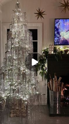 a christmas tree made out of tinsel is shown in front of a television screen