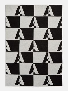 a black and white rug with letters on it