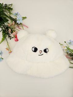 a white teddy bear laying on top of flowers