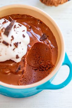 a bowl filled with chocolate pudding and whipped cream