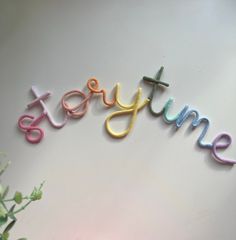 the word jesytime spelled with colored crochet letters on a white surface