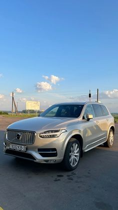 a silver car is parked on the side of the road