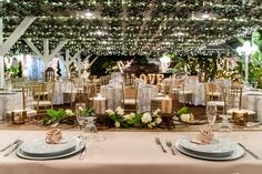 the tables are set with white linens and place settings for an elegant wedding reception