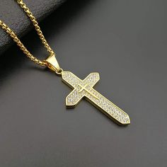 18K Gold Plated Cross Necklace Stunning 18K Gold Plated Design: Elevate your style with our non-tarnish, gold-plated Catholic box chain necklace, radiating elegance and durability. Superior Craftsmanship: Our expertly designed Catholic necklace features intricate detailing and a durable 18K gold plating that resists fading and discoloration. Compact and Stylish Design: This pendant features a sleek 68x32cm cross with a slender 3mm width, complemented by a 60cm chain for a modern and elegant look Gold Cubic Zirconia Cross Pendant Necklace, Gold Cubic Zirconia Box Chain Necklace, Gold Cubic Zirconia Jewelry With Box Chain, Gold Jewelry With Vvs Clarity Cross Pendant, Gold Vvs Clarity Cross Pendant Jewelry, Gold Cross Necklace With Cubic Zirconia, Catholic Cross, Catholic Necklace, Pendant Making