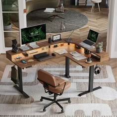 a computer desk with two laptops on it and a chair in front of it