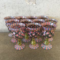 a bunch of vases sitting on top of each other in front of a wall