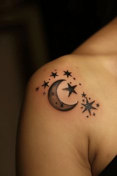 a woman's shoulder with stars and a crescent tattoo