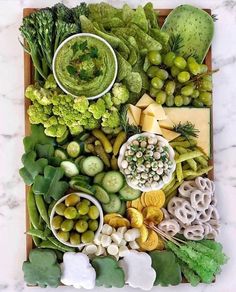 a tray filled with different types of vegetables and dips on top of each other