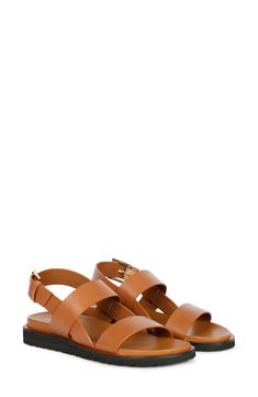 A rich leather upper adds timeless sophistication to strappy sandal fitted with an adjustable slingback strap for a customized fit. 1 1/4" heel Adjustable slingback strap with buckle closure Leather upper and lining/rubber sole Imported Classic Leather Slingback Sandals With Buckle Closure, Leather Strappy Slingback Pumps, Brown Leather Slingback Sandals With Tang Buckle, Classic Summer Slingback Sandals With Buckle Closure, Modern Strappy Leather Slingback Sandals, Leather Slingback Sandals With Tang Buckle And Open Heel, Formal Slingback Sandals With Tang Buckle, Classic Open Toe Sandals With Adjustable Straps, Classic Open Toe Slingback Pumps With Buckle