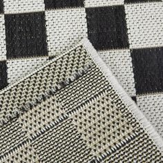 two black and white checkered rugs on top of each other