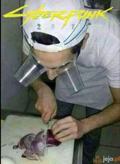 a man cutting onions on top of a cutting board