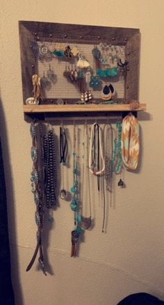 a wall mounted jewelry rack with lots of necklaces