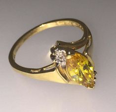 14K Yellow Gold Golden Zirconia of fine vivid yellow colour Round brilliant cut diamonds Ring's size: N (can be resized) Total item's weight: 2.6gr.  Comes with box & valuation 14k Gold Yellow Diamond Ring, Yellow 14k Gold Diamond Ring, 14k Gold Yellow Rings With Accent Stones, Yellow Birthstone Ring With Accent Stones, Yellow Diamond Ring In 14k Gold, Yellow Sapphire Ring With Diamond, Fine Jewelry Yellow Birthstone Ring With Center Stone, Yellow Gemstone Birthstone Ring In Fine Jewelry Style, Formal Yellow Sapphire Ring In Fine Jewelry Style